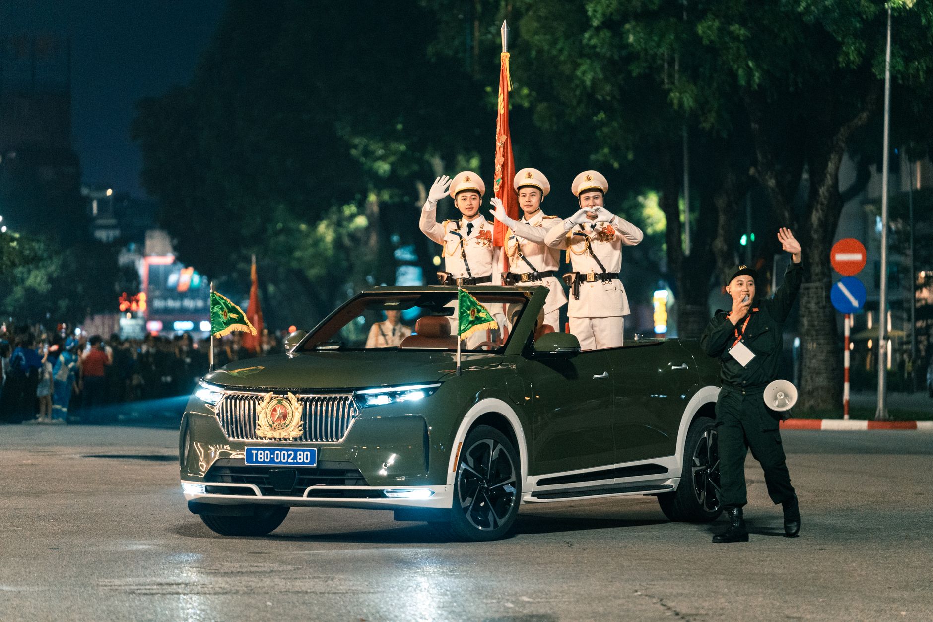 Vietnamese officers in uniform during a night parade in Hanoi, showcasing military pride.