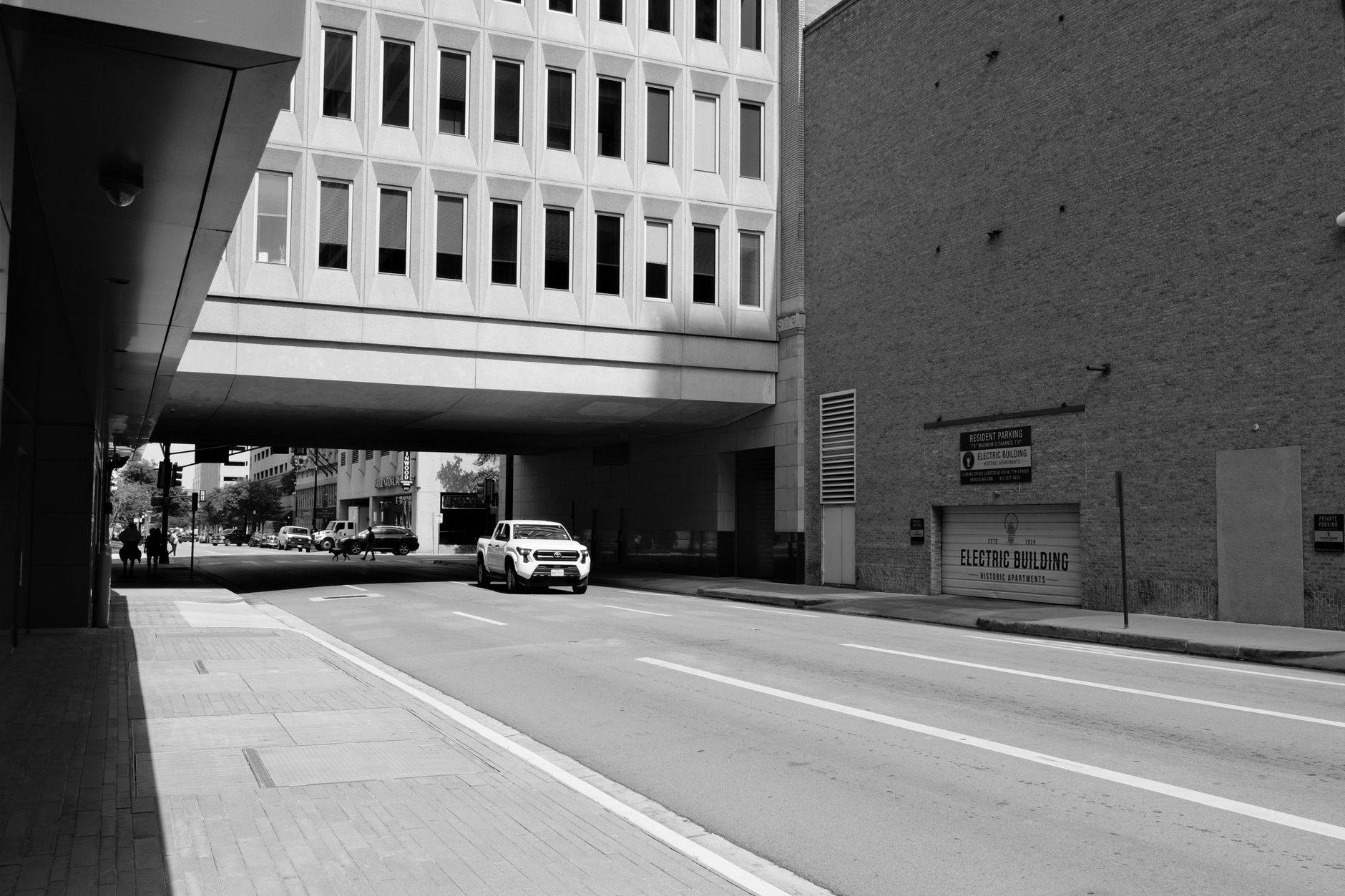Black and white urban scene of downtown Fort Worth street with modern architecture.