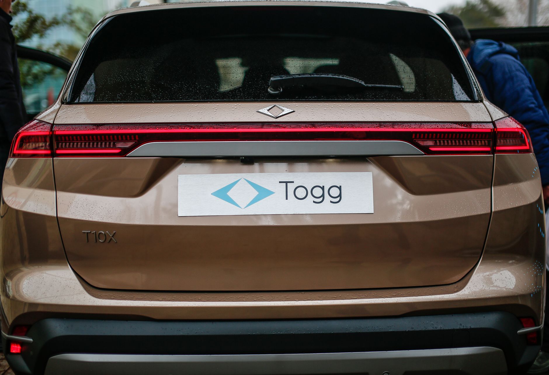 Rear view of a brown TOGG T10X electric SUV in Malatya, Türkiye, showcasing modern design.