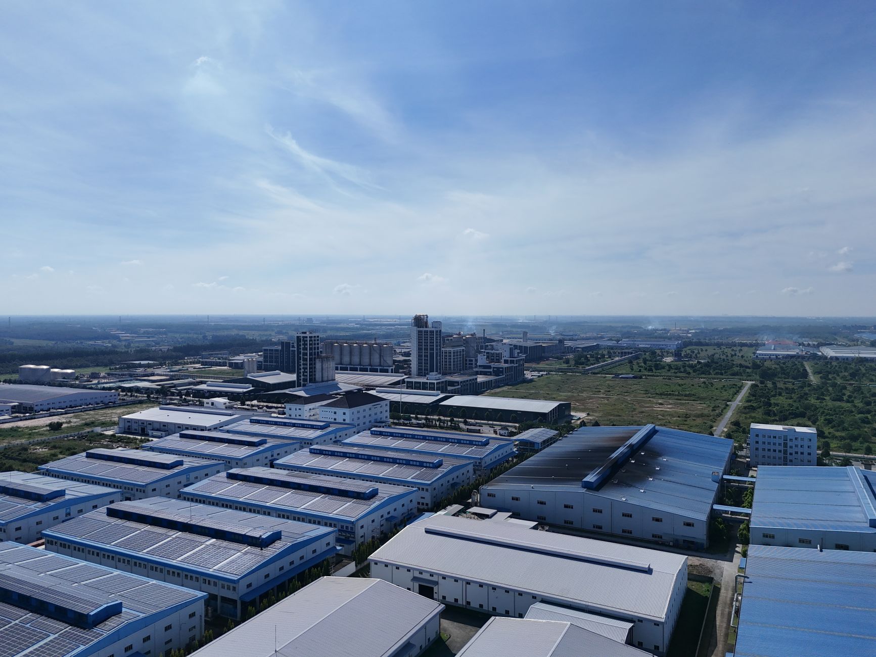 Aerial shot of industrial warehouses under blue sky in Bình Dương, Vietnam.