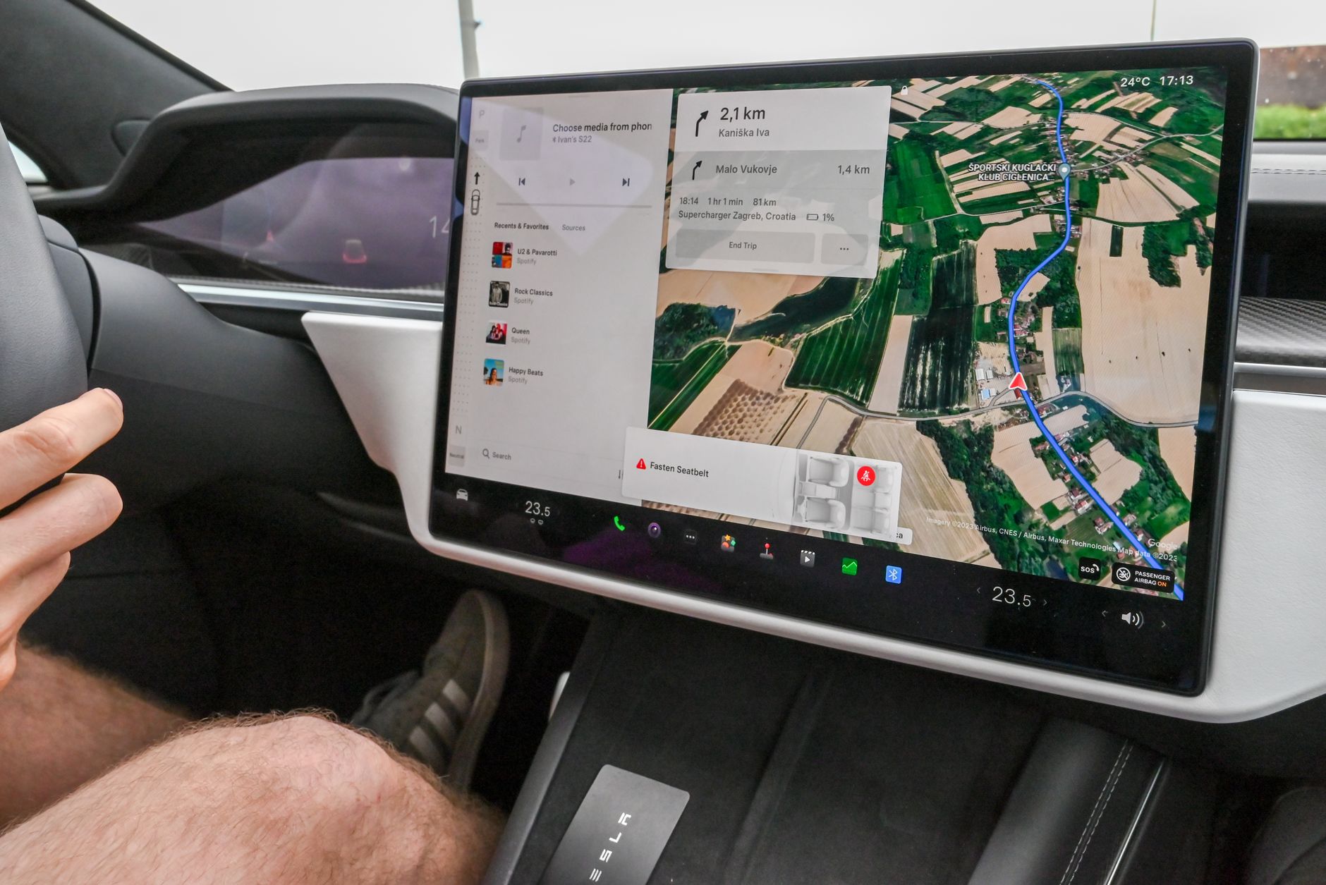 Inside view of a car with a large navigation screen and detailed digital map.