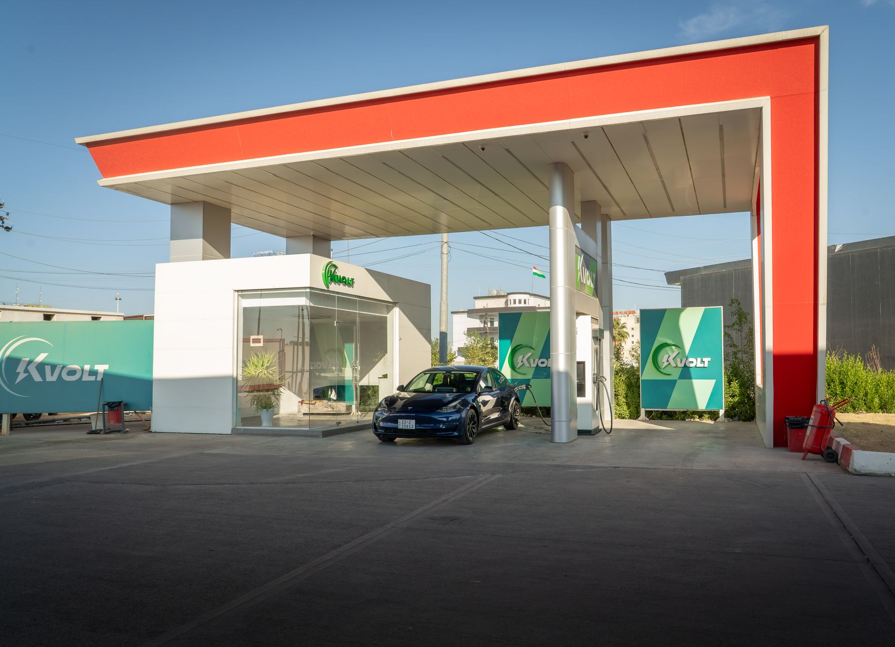 A sleek electric car charging at a modern station with blue skies in the background, promoting eco-friendly travel.
