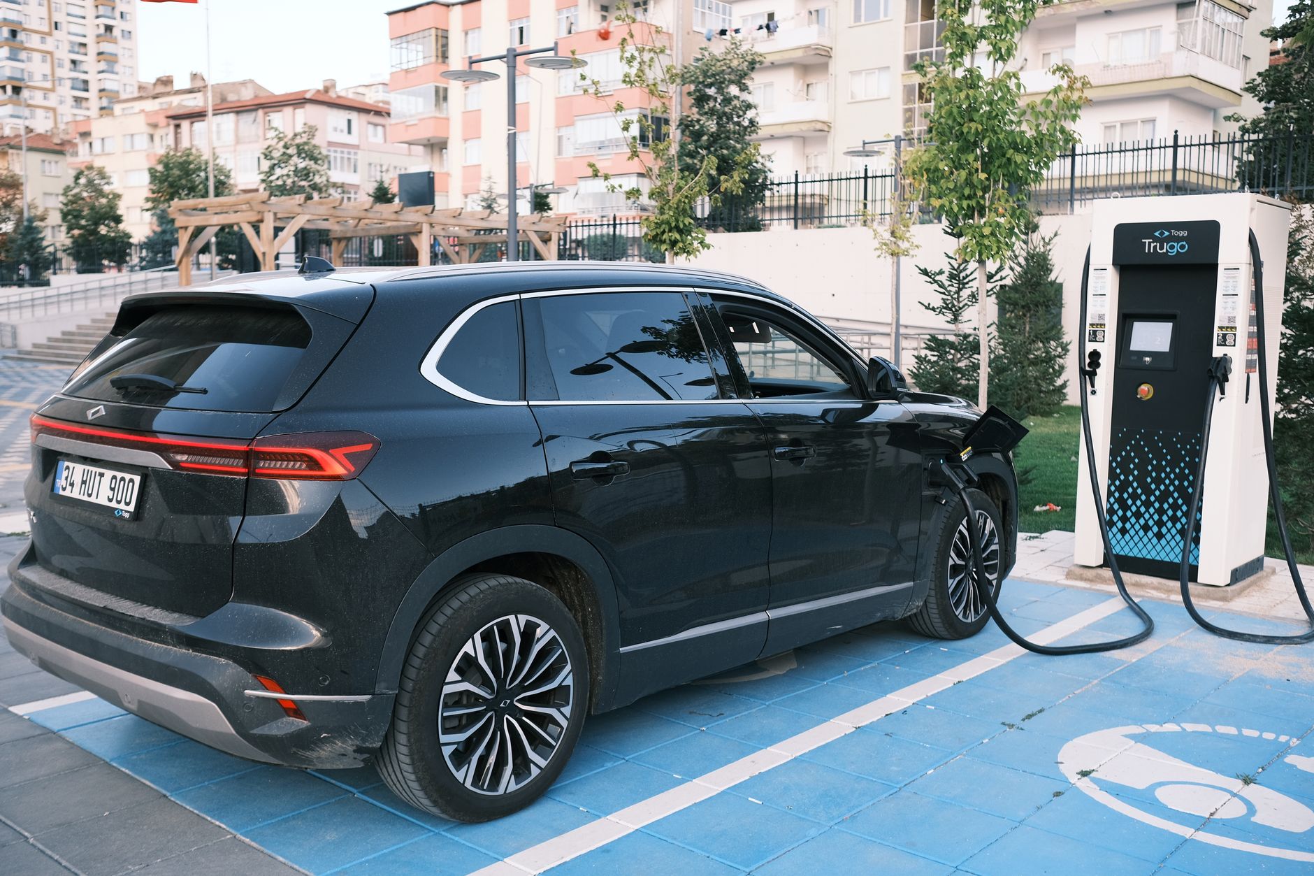 Electric car charging at a station in Niğde, Türkiye, highlighting clean energy.