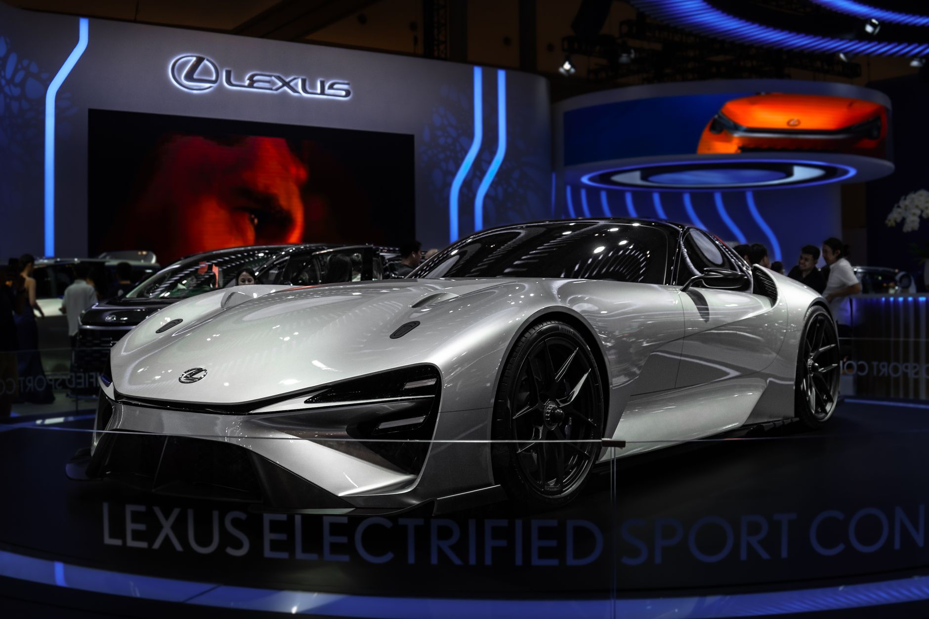 Lexus Electrified Sport Concept car showcased at an indoor auto exhibition with modern lighting.