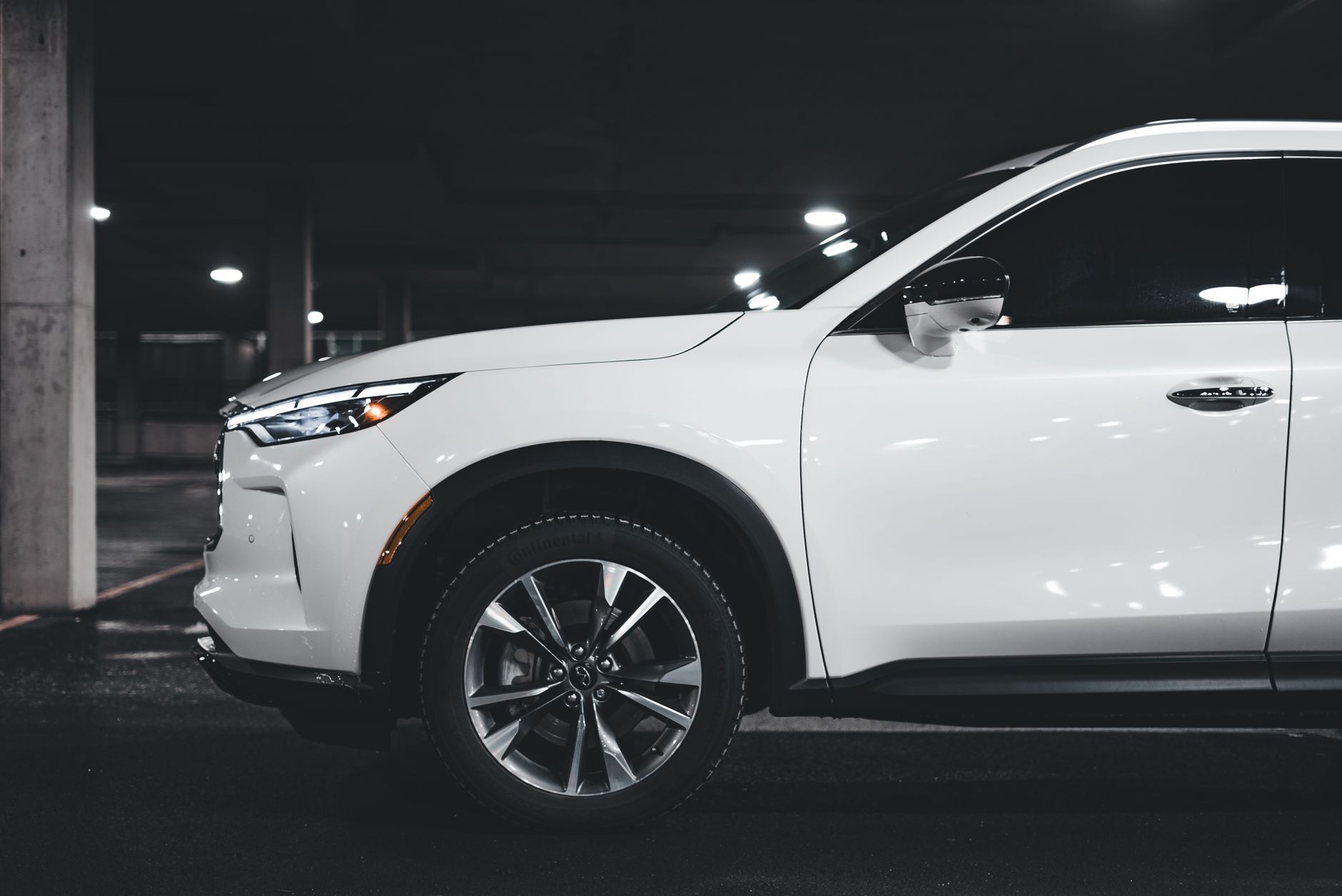 A stylish white SUV parked in an urban garage showcasing modern luxury design elements.