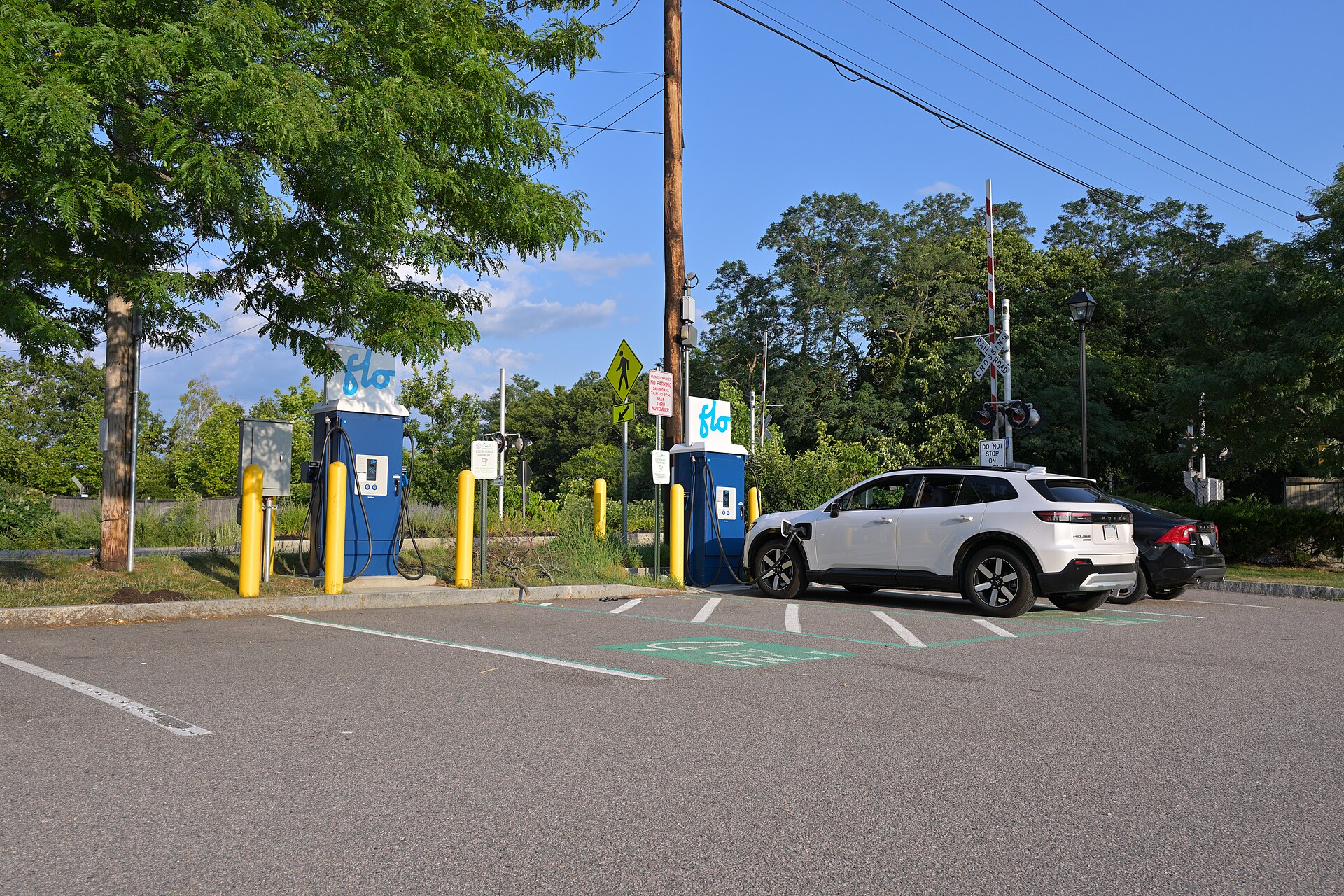 A Honda Prologue charges at a Flo DC fast charging station at the parking lot at Hingham Depot